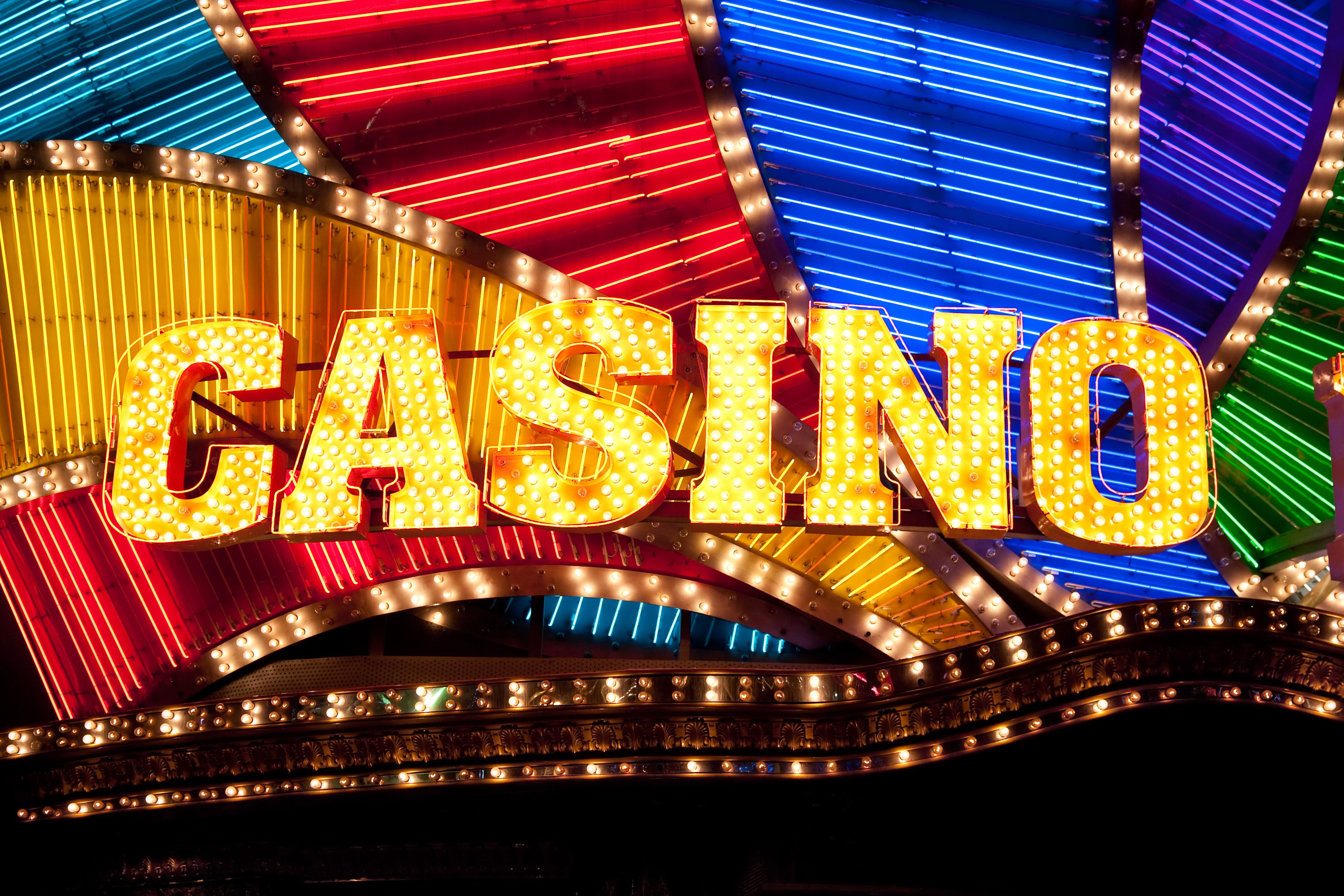 A hand holding a smartphone with a casino bonus code displayed on the screen.